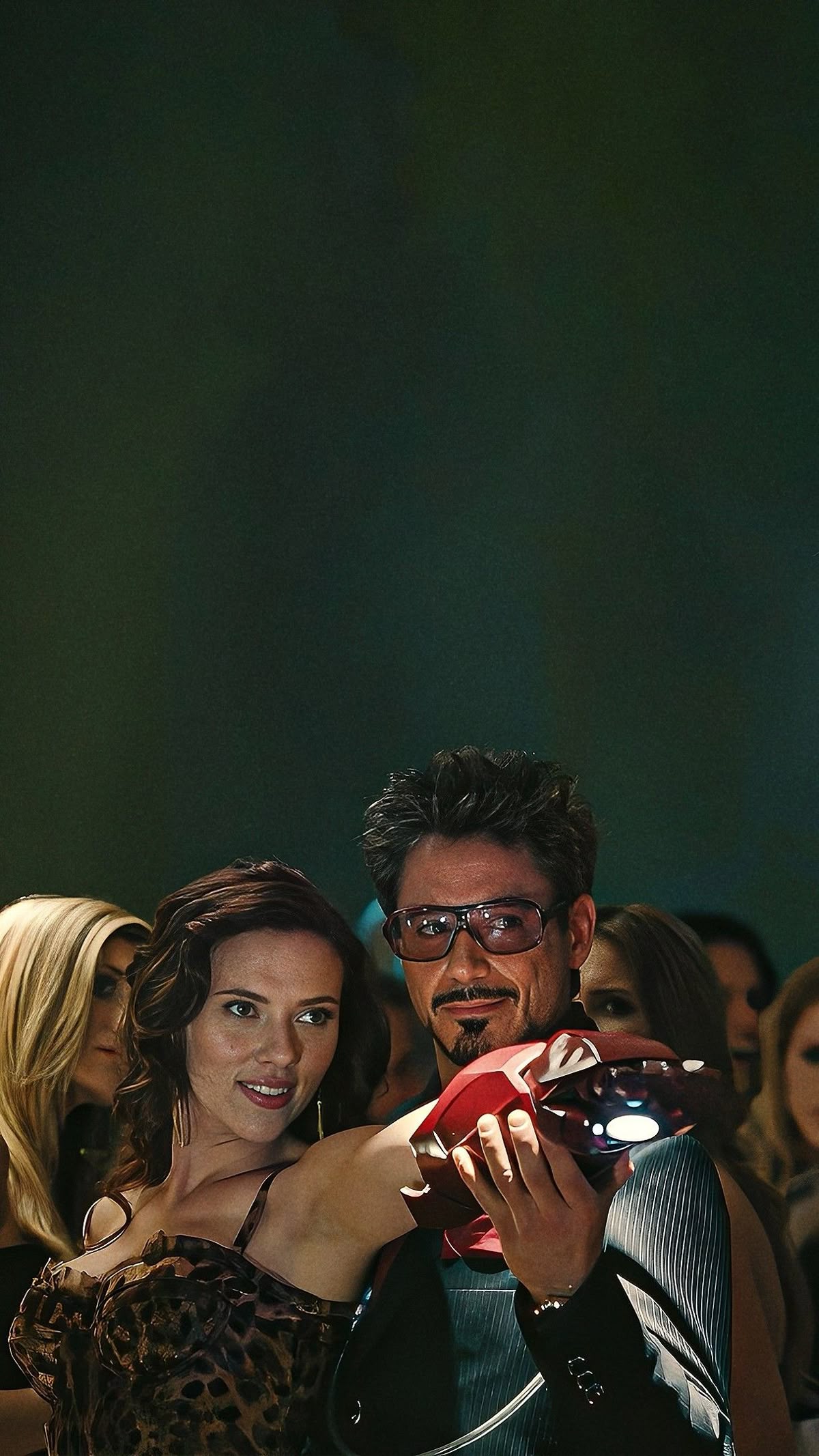 Tony Stark holding Iron Man helmet