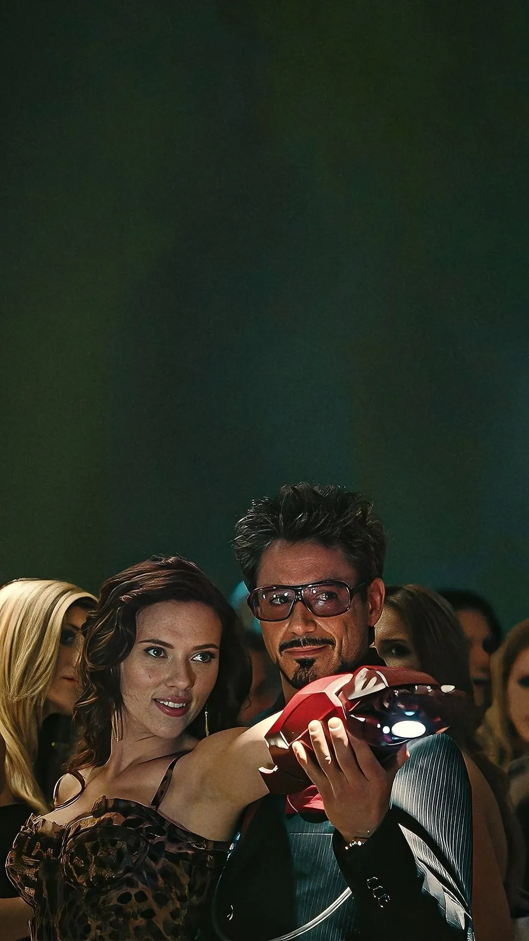 Tony Stark holding Iron Man helmet