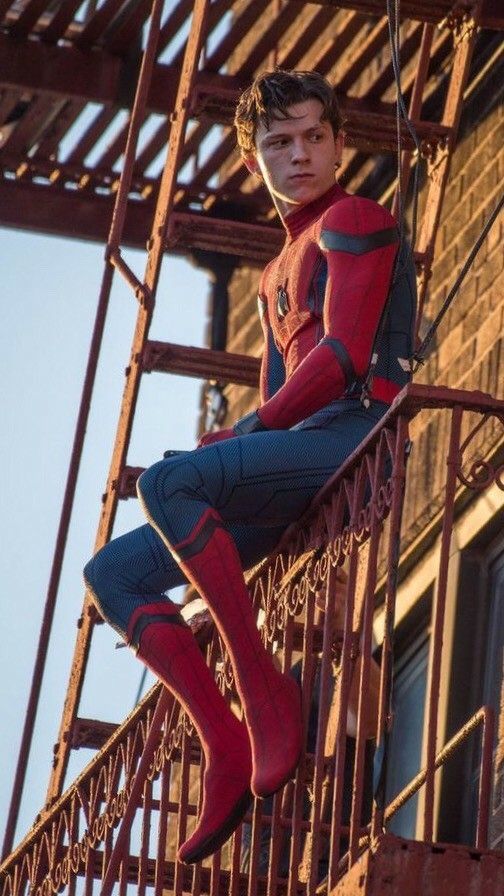 Peter Parker sitting on a Queens fire escape