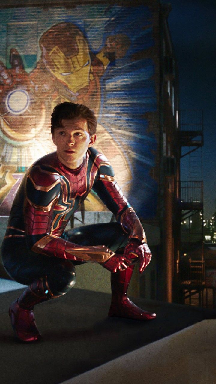 Peter Parker in Iron Spider suit crouching on rooftop